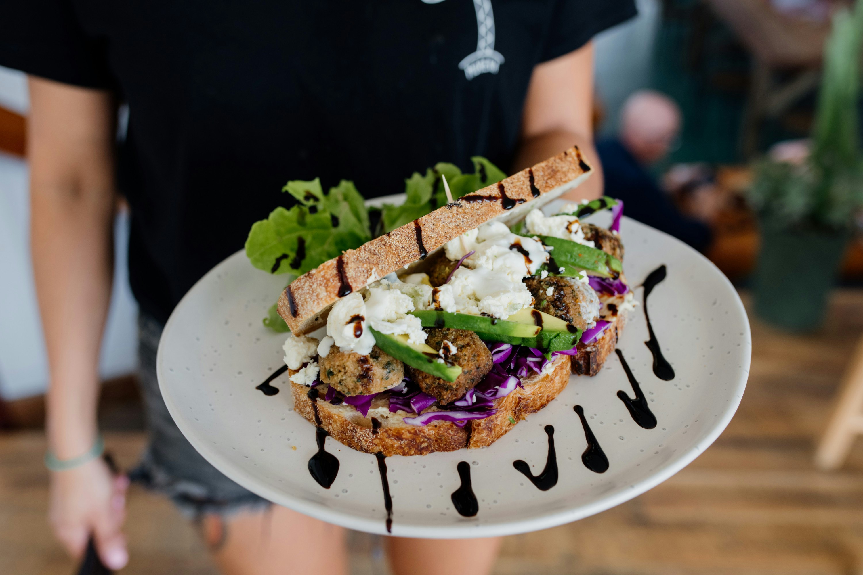 a close up of a smashed avo sandwich